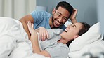 Couple, laughing and love bond in bedroom in house, home interior or honeymoon hotel. Smile, happy and comic man or asian woman with boyfriend in fun play game in security, trust and safety marriage