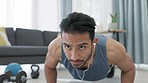 Man doing exercise for fitness workout with music, listening to podcast for exercise motivation and training for strong body in the living room in house. Asian sports person with power doing pushups
