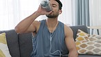 Fitness man, home workout break and water bottle for healthy after training, exercise and sports wellness. Tired, breathing and challenge athlete drinking for rest, thirst and strong body refresh
