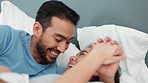 Young, happy and playful couple in bed in the morning, smiling and laughing. Mixed race man and asian woman in bedroom, having fun and showing affection. Bonding, loving and quality time