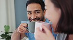 Happy couple, morning coffee and laughing while talking and bonding in the bedroom while sitting together and sharing joke. Happy asian man and woman with good communication in a healthy relationship