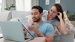 Savings, investment and finance planning with a couple reading paperwork at home with a laptop. Money, growth and banking with a young man and woman thinking about the future in their living room