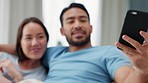 Couple selfie, phone smile and relax on the sofa in home, happy with mobile app on technology and love in marriage with smartphone. Asian man and woman with photo for social media with tech on couch
