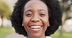 Black woman, beautiful smile and nature park feeling happy and laughing with afro hair while standing outside and having fun. Closeup portrait of a confident African female with a positive mindset
