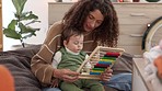 Mother, baby and kid education growth at a house learning numbers on a abacus. Child development experience of a child and woman together at a family home learn hand motor skills and brain activity