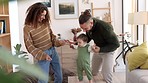 Baby, dance and family with a mother, father and their child dancing and having fun in their home together. Love, freedom and happy with a man, woman and their daughter laughing in the living room
