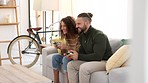 Gamer, video game and happy couple arcade gaming playing a fun competition together in an apartment loft. Relaxed, smile and excited young woman enjoys a competitive experience with a young partner 