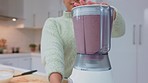 Woman with smoothie drink blender for healthy, clean diet lifestyle in her kitchen. Happy nutritionist making a strawberry fruits milkshake for energy, detox or breakfast food in her home