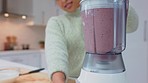 Milkshake, strawberry and woman healthy smoothie in a blender to make a vegan fruit juice with vitamins at home. Girl using an electric mixer to detox with a protein diet, fiber and healthy nutrition