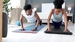 Young couple in their home doing yoga and exercise together. Black man and black woman in relationship using yoga mats, exercising and doing push ups in their bedroom. Fitness, workout and training