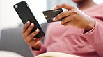 Black woman hands, phone and credit card for ecommerce, online shopping and bank app in house living room or home interior. Zoom on technology fintech, e commerce software or lockdown retail customer
