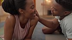 African couple resting after doing a yoga exercise together for wellness, health and energy at home. Happy, young and black people kissing and relaxing after a meditation or pilates practice.
