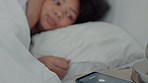 Woman in bed snooze alarm on phone, sleep more on pillow after stop notification or buzz. Girl awake from noise on smartphone in bedroom, end sound and does more sleeping, on weekend or holiday