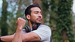 Asian man stretching body in forest before exercise, training and workout in a nature forest. Athlete with fitness practice and warm up arm outdoor before cardio or run for a healthy lifestyle