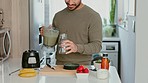 Asian man, green smoothie and healthy juice for weight loss, detox and breakfast diet in home kitchen. Happy smile and house nutritionist with fruit cocktail beverage and vegan vitamins morning juice