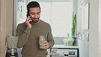 Phone, smoothie and health with a man drinking juice in the kitchen of a home for health and wellness. Nutritionsist, weight loss and diet with a young male taking a drink for nutrition and vitality