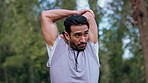 Healthy, workout and fitness stretching in a forest during his morning exercise, run and training. Man or Runner doing a muscle warm up before running in the woods to maintain his health and wellness