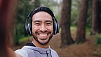 Asian man, fitness music headphones or live streaming selfie in nature forest or countryside trees background. Happy smile portrait of hiking, workout athlete muscle flex for social media photograph