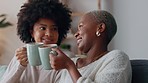 Friends relax and women talk with hot chocolate drink as they enjoy discussion together. Happy girl friendship, conversation and cheers while speaking of positive development in apartment.