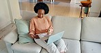 Phone call, laptop and sofa, a black woman working from home in living room. Communication, internet and freelance work online, talking on smartphone and writing email, multitasking with a smile.