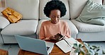 Freelance woman, stress and frustrated with phone call while working on laptop explaining and talking about error, glitch or internet problem. Unhappy black female remote worker working from home