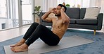 Fitness, sit ups and man training in his home exercising his abdominal, belly and strong stomach muscles on an apartment floor. Calisthenics, healthy and young athlete busy with workout and exercise 