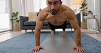 Man, exercise and workout on floor, in living room of home or apartment. Latino guy, shirtless training and fitness for physical wellness and muscle development in lounge at his house with yoga mat