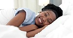 Bedroom wake up, black woman portrait and happy morning after sleeping on comfortable soft pillow for healthy rest, nap and break. Face of smile young african female in bed for peaceful calm relaxing