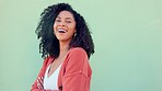 Freedom, happy and smile with a woman laughing and standing arms crossed outside on a green wall background. Funny, joke and laugh with a carefree young female feeling cheerful and positive outdoor