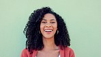Smile, laughing and happy black woman on green wall background. Portrait face of funny, young and comedy young female with natural afro hair, freedom and happiness for life, motivation and crazy joke