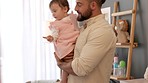 Father, daughter and newborn baby in toy fun for early childhood development and family time at home. Man in parenthood bonding and holding little girl in happy playtime and walking in the house