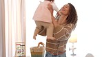 Baby, family and love with a girl and her mother bonding, laughing and joking together in their home. Children, parent and carefree with a young woman and her adorable daughter loving with joy