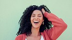 Black woman smile, play with natural hair and happy against green backdrop or wall. Beautiful model girl with healthy curly afro, show expression of happiness against mint green background outside