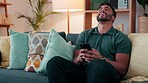 Laughing man, social media and winning mobile phone games on sofa lounge at home. Happy guy watching funny internet meme, reading online success notification and deal celebration, discount and bonus