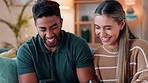 Phone, happy and couple on social media in the house and enjoy scrolling and sharing funny online content together. Smile, interracial and young woman laughing at memes with Indian partner on sofa 