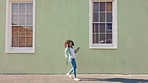 Girl walking, dance and listening to music on headphones happy, excited and on street sidewalk travel copy space. Peace, freedom or wellness for relax black woman dancing and streaming fun radio song