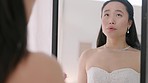 Happy Chinese bride in wedding dress, ireflection in mirror and thinking about future after marriage. Fashion, makeup and beauty skin routine. Asian woman looking at ring finger, nervous and excited 