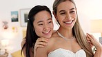 Wedding, bride and bridesmaid looking happy, proud and excited share hug, joy and love wearing white dress and ready for ceremony. Interacial asian woman and friend laughing waiting for a celebration