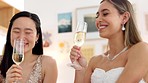 Wedding, bride and toast with a woman and her bridesmaid drinking champagne before a marriage ceremony or celebration event. Glass, cheers and celebrating with a young female laughing with a friend 