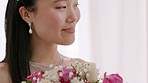 Asian bride before wedding, smile with bouquet and jewellery, with excited and proud expression on face. Young woman happy with flowers in hand before going to marriage ceremony, dance or event