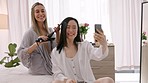 Hair iron, selfie and influencer women in bedroom for friends holiday vacation at a luxury hotel. Friends, people and asian woman taking portrait photography on smartphone to post on social media 
