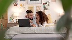 Relax, laptop and couple streaming in a bedroom, planning a fun vacation and searching the internet for online deal. Love, happy and caring man and woman enjoying a movie and social media together
