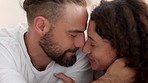 Couple kiss, bed relax and happy with love in bedroom of house together, smile for marriage and happiness in apartment. Playful man and woman kissing forehead and affection in home for security