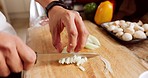 Cooking, cutting onion and hands of chef making food or dinner with knife and chopping board for vegetables with culinary skills. Male home cook with healthy, organic and fresh ingredients in kitchen