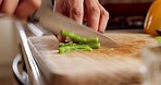 Green pepper, wood board and knife in hands of a chef man cooking in kitchen for healthy lunch. Fast, experience and culinary person with vegetable for restaurant or home dinner salad close up