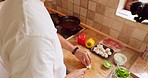 Lunch salad, vegetable cooking and Asian man cutting food with a knife in the kitchen, happy with nutrition for dinner and  preparing mushroom for diet. Healthy chef hungry for breakfast in morning