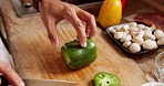 Chef Knife, hand and green pepper or vegetables cut on wood board, to prepare food in kitchen or restaurant. Professional cook chop healthy food, cooking in workplace for nutrition meal or salad