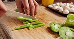 Chef in kitchen, with knife and healthy vegetables cutting on wood board, to prepare food in home or restaurant. Professional cook chop green pepper, cooking in workplace for nutrition meal or salad