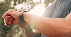 Fitness, exercise and digital watch with man checking health tracker during a workout outdoors. Wellness, technology and tracking closeup of smartwatch on training male doing cardio and endurance run