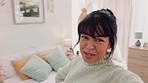 Influencer woman in bedroom interior live streaming video POV for social media excited for her apartment, home or real estate. Gen z student recording dorm room design and furniture for online app